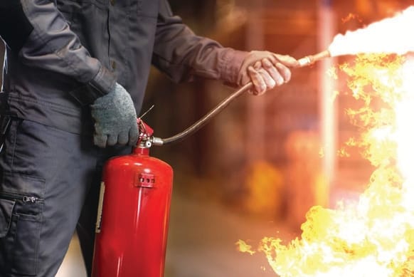 Masterfound Security fire marshal demonstrating a fire extinguisher